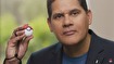 Reggie Fils-Aime with a Pokeball Plus containing Mew.